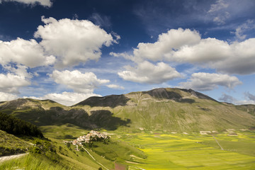 Famous mountain village of Castelluccio di Norcia with beautiful summer landscape at Piano Grande...