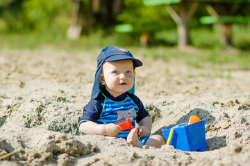 Cute kid playing in the sand  
