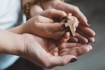 Family prayer with wooden rosary