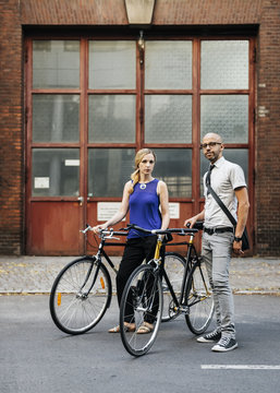 Germany, Berlin, Man and woman standing with bicycles