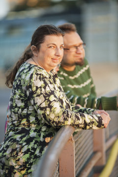 Sweden, Sodermanland, Stockholm, Sodermalm, Slussen, Friends leaning against railing at sunset