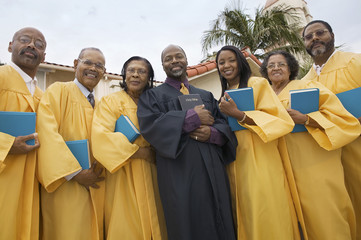 Preacher and Choir in church garden portrait low angle view