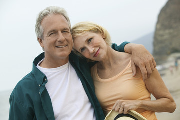 Portrait of a couple man with arm around a woman at the beach