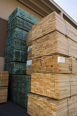 Stack of wooden planks arranged in warehouse