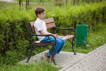 offended child sitting in a chair outdoors