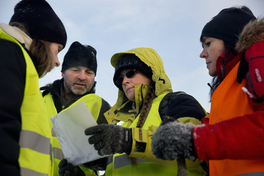 Volunteers discussing together while looking at map