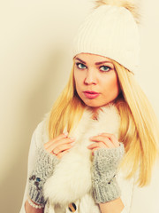 Woman in winter clothes woolen cap fur scarf