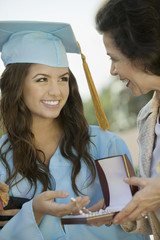 Graduate Receiving necklace from Grandmother outside