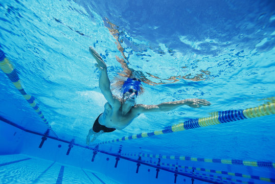 Low angle view of a young man swimming underwater