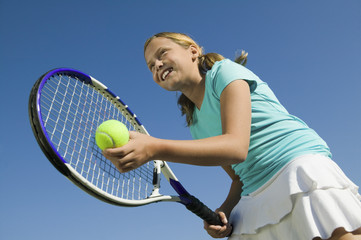 Young girl on tennis court Preparing to Serve low angle view close up