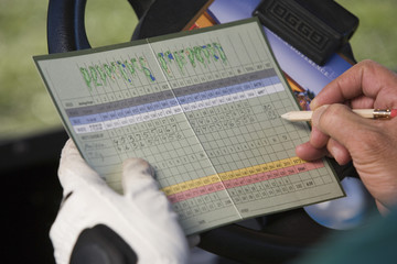Close-up of a male golfer writing golf score
