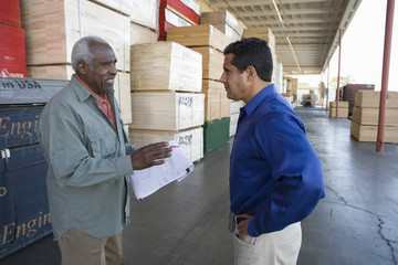 Warehouse workers stocktaking in timber factory