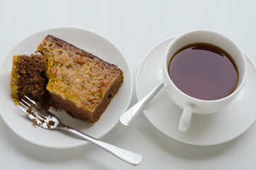 Caramel Peanut-Topped Brownie Cake with A Cup of Tea.