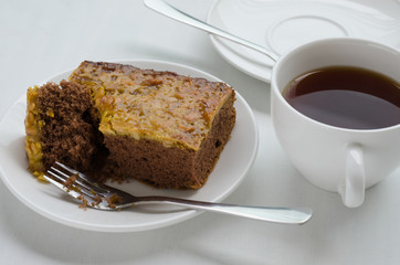 Caramel Peanut-Topped Brownie Cake with A Cup of Tea.