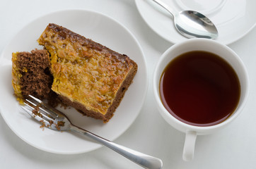 Caramel Peanut-Topped Brownie Cake with A Cup of Tea.