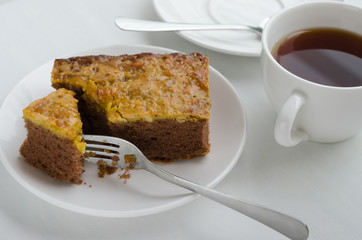 Caramel Peanut-Topped Brownie Cake with A Cup of Tea.
