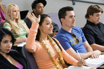 Female student raising hand during class lecture
