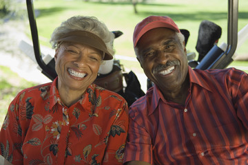 Portrait of a happy African American couple in golf cart