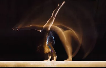  Multiple exposure image of female gymnast in motion on balance beam © moodboard