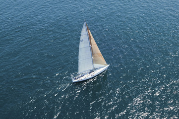 Elevated view of a sailboat at the peaceful blue ocean
