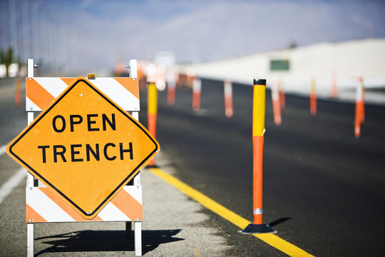Open Trench' sign on street