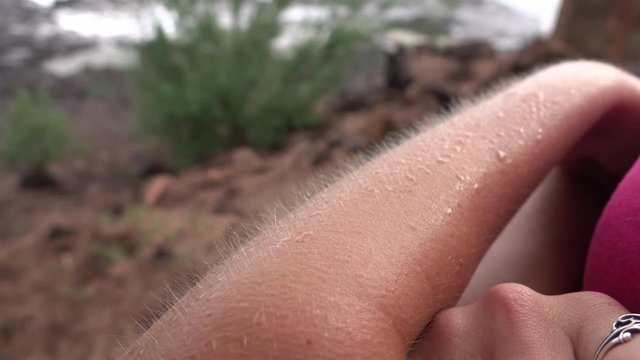 MACRO: Chills on human skin on cold, windy day. Goosebumps on white female arm.
