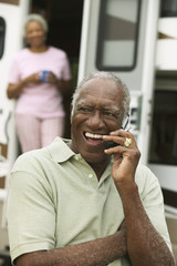 Senior man using mobile phone outdoors