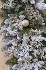 Christmas festive decorations with pine twig, baubles, artificial snow