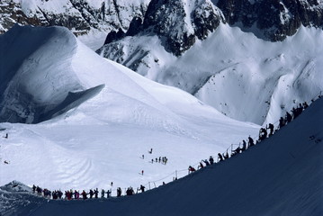 Figures silhouetted walking along the ridge at the top of the Vallee Blanche, Mont Blanc, Chamonix, Rhone Alpes, France