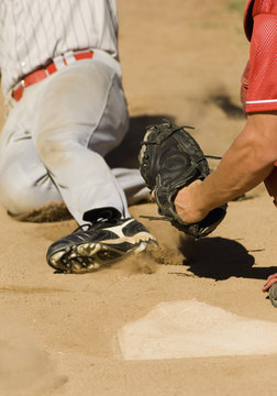 Player sliding towards the base to complete a run