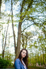 beautiful girl in a dress in the spring in a mask of dry leaf