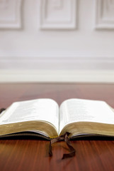 Opened Bible on a Wooden Floor.