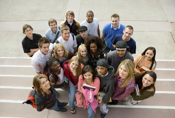 High angle portrait of multiethnic college students on steps