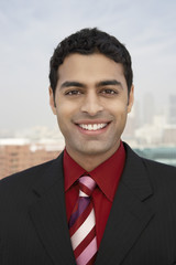 Closeup portrait of a young mixed race businessman smiling outdoors
