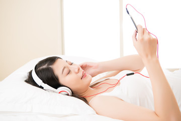 asian woman enjoy music by smart phone with headphones