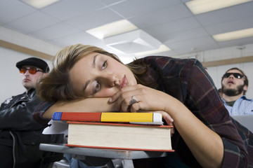 Bored woman and classmates in lecture hall