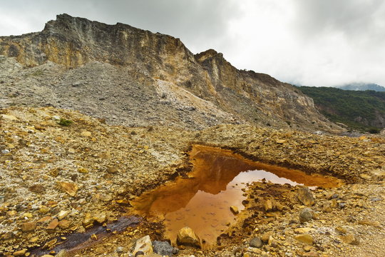 Mineral stained pond on collapsed flank of Papandayan Volcano, an active four crater caldera, Garut, West Java, Java, Indonesia
