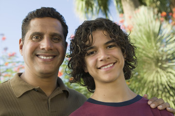 Father with Arm Around Son (13-15) front view portrait.