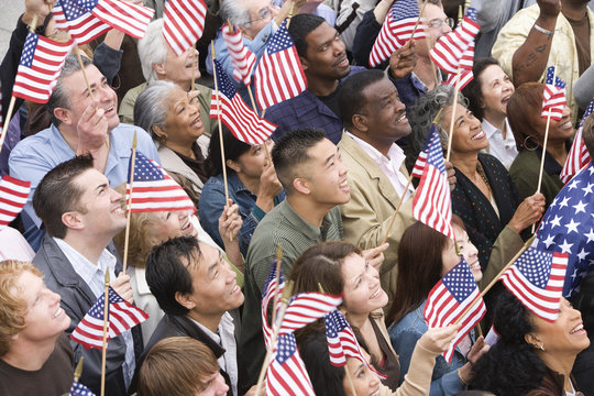High angle view of happy multi ethnic people holding American flag