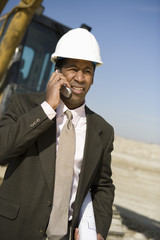 Architect wearing headhat as he's on call at construction site