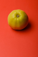 Apple isolated on red background