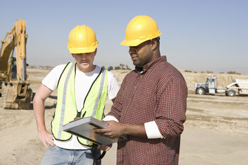 Foreman informing work to worker at construction site