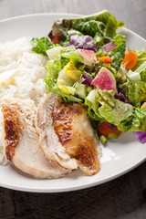 Italian salad with rotisserie chicken and white rice close shot