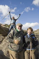 Tuinposter Portrait of happy senior couple with excited woman in background on hiking trip © moodboard