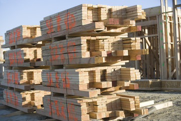 Stacked of wooden planks at construction site