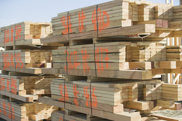 Wooden beams stacked at construction site