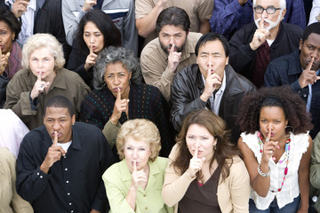 High angle view of multiethnic people with finger on lips