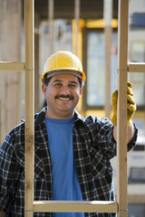 Portrait of mature Hispanic worker at construction site