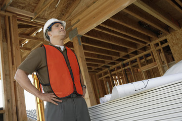 Engineer looking up at the framework in construction site