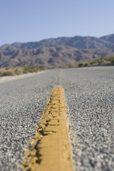 Close-up of road with yellow line on it